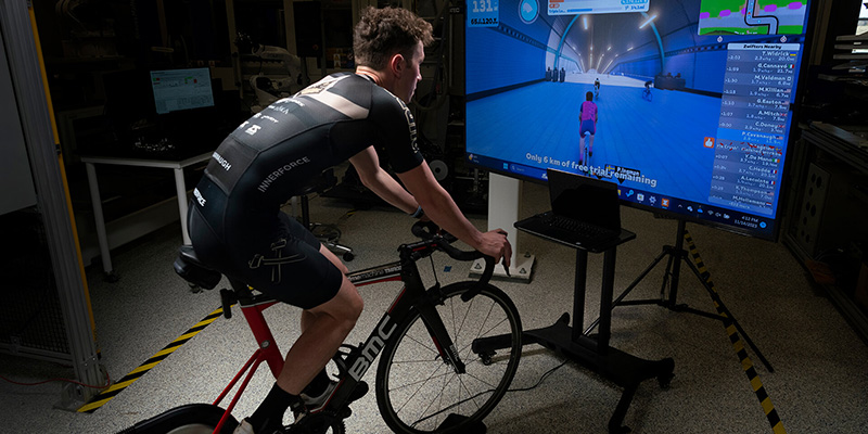 Patrick Cavanaugh, a research engineer at Purdue’s Ray Ewry Sports Engineering Center, demonstrates how virtual cycling competitions function in a remote environment. (Purdue University photo/John Underwood)