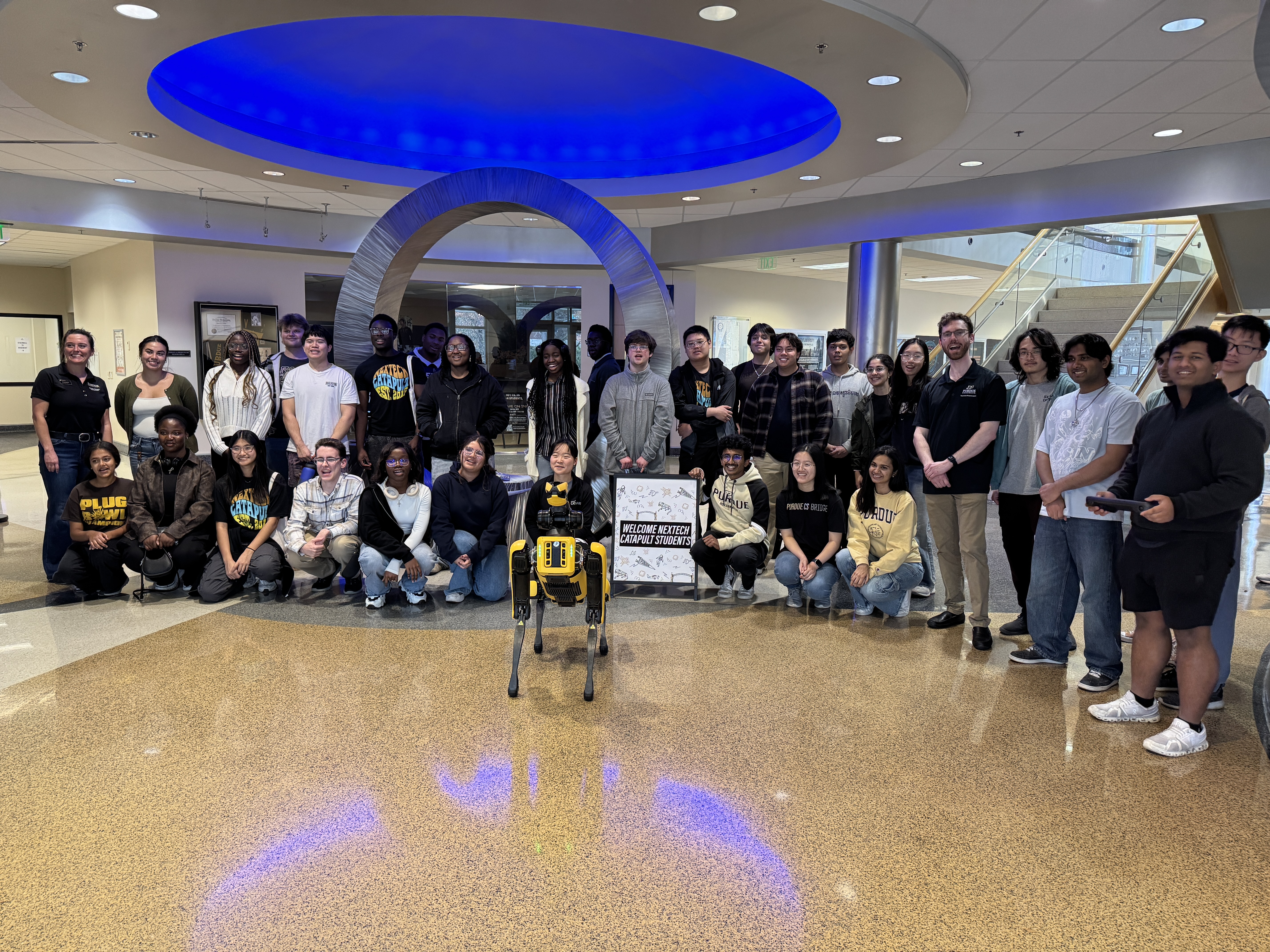 students with robot dog in lawson computer science building